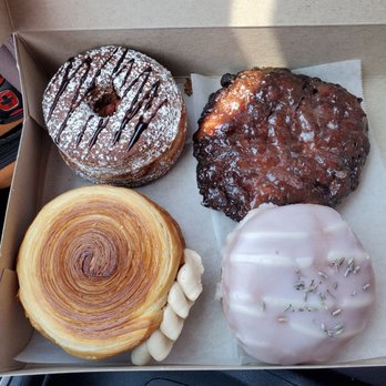 Friendly Donuts - Clockwise from top left: nutella strawberry cronut, guava fritter, lavender vanilla donut with rose cream, and cookie butter croissant wheel - Donuts Near Me - Orange, California Friendly Donuts - Clockwise from top left: nutella strawberry cronut, guava fritter, lavender vanilla donut with rose cream, and cookie butter croissant wheel - Donuts Near Me - Orange, California