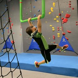 Synergy Climbing And Ninja - Boy on hanging obstacle, ninja course.