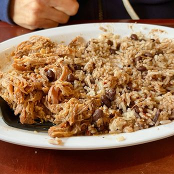 Paseo - Pulled pork with Mexican rice and jasmine beans and corn grilled with mayonnaise and spices on top - Caribbean Near Me - Seattle, Washington