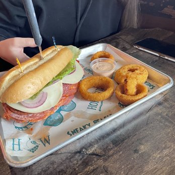 The Grumpy Monk - Italian sandwich. Boring. They did bring her more onion rings though. - Bars Near Me - Myrtle Beach, South Carolina The Grumpy Monk - Italian sandwich. Boring. They did bring her more onion rings though. - Bars Near Me - Myrtle Beach, South Carolina