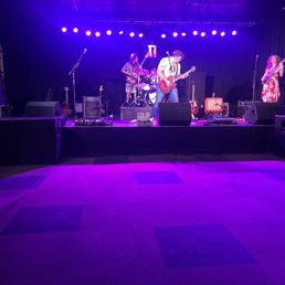 the band on stage with purple lighting