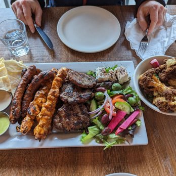 Saha Eatery - Meshwi Platter: 3 beef kefta, 2 harissa chicken kabobs, 3 lamb merguez sausage, zaatar roasted potatoes, feta, pita bread, & all the sauces - Lebanese Near Me - Squamish, British Columbia Saha Eatery - Meshwi Platter: 3 beef kefta, 2 harissa chicken kabobs, 3 lamb merguez sausage, zaatar roasted potatoes, feta, pita bread, & all the sauces - Lebanese Near Me - Squamish, British Columbia