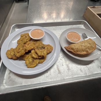 Casa Borinquena - Side of Tostones (left) and Lulu's Famous Pastelillo (right) at $6 each - Puerto Rican Near Me - San Francisco, California Casa Borinquena - Side of Tostones (left) and Lulu's Famous Pastelillo (right) at $6 each - Puerto Rican Near Me - San Francisco, California