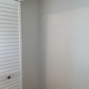 Helping Hands Construct - After photo of inside of closet. New wall and flooring. Unfinished bottom trim is because closet system will fit in there. - General Contractors Near Me