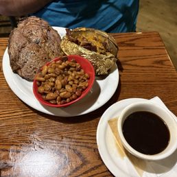 Prime Rib with a loaded baked potato and baked beans Prime Rib with a loaded baked potato and baked beans