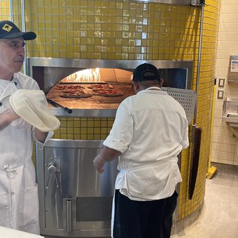 California Pizza Kitchen - the Pizza is cooking - Pizza Near Me - Manhattan Beach, California California Pizza Kitchen - the Pizza is cooking - Pizza Near Me - Manhattan Beach, California