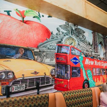 Chompie's - a red double decker bus and a yellow taxi - Delis Near Me - Glendale, Arizona