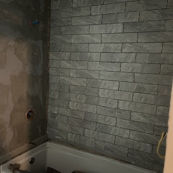 Stonewood Flooring And Tile - a bathtub and shower - Flooring Near Me