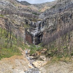 Continuing along...a picturesque stop on the drive. Here a small running waterfall off a rock wall in the distance...
