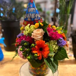 Candy in between two vases for a very FUN rainbow arrangement!