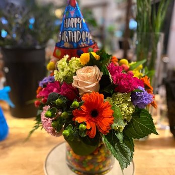 Zins Flower Shop - Candy in between two vases for a very FUN rainbow arrangement! - Florists Near Me - Chicago, Illinois