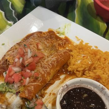 Campo Azul Mexican Kitchen - Chicken enchiladas with rice and black beans, you notice most of the guacamole is already gone - Mexican Near Me - Summerfield, Florida