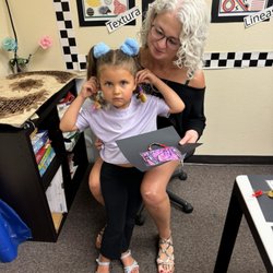 Casa de Español - Showing off the earrings she made in art class.