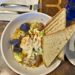 Magdalena's Creperie - Turkish Cilbir: poached egg on garlicky dill yogurt, avocado, pan fried potatoes in Aleppo chili oil with sourdough. Must try!