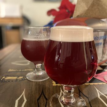 Blue River Taphouse - two glasses of beer on a table - Hot Dogs Near Me - New Castle, Indiana Blue River Taphouse - two glasses of beer on a table - Hot Dogs Near Me - New Castle, Indiana