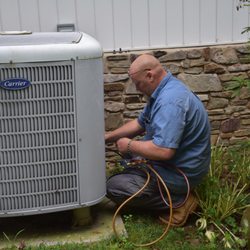 Hendershot Heating & Cooling - Inspecting an air conditioning unit.