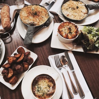 Tilikum Place Cafe - French onion soup (middle), Wild Boar special (mid right), and two Baked Eggs (top). - New American Near Me - Seattle, Washington