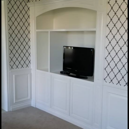 Built-in, a small portion of wainscoting, small portion of crown and door casing to left.