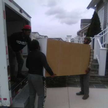 Marbury Movers - Our team hard working together to navigate an item into the home. - Movers Near Me Marbury Movers - Our team hard working together to navigate an item into the home. - Movers Near Me