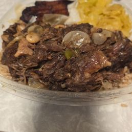 Oxtails on a bed of rice, Plantains, and Cabbage Oxtails on a bed of rice, Plantains, and Cabbage