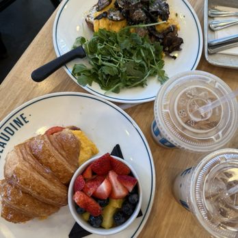 Claudine Kitchen & Bakeshop - Breakfast croissant royale and  truffled mushroom toast with side of arugula salad and fruits - vale vale latte and vanilla iced latte. - Breakfast & Brunch Near Me - Porter Ranch, California