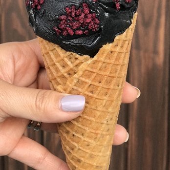 The Greenery Creamery - Black ash coconut in a vanilla chia waffle cone topped with hibiscus crystals - Ice Cream & Frozen Yogurt Near Me - Sanford, Florida The Greenery Creamery - Black ash coconut in a vanilla chia waffle cone topped with hibiscus crystals - Ice Cream & Frozen Yogurt Near Me - Sanford, Florida