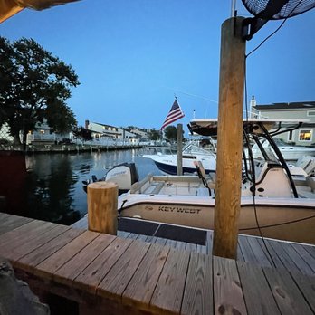 Anchor Down Dockside - a boat docked at a dock - Seafood Near Me - Seaford, New York