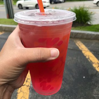 Dunkin' -  a hand holding a plastic cup with a straw - Coffee & Tea Near Me - Burlington, Massachusetts