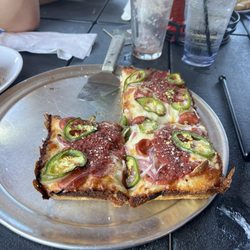 Detroit style crust , red sauce jalapeños..,red onion and pepperoni.