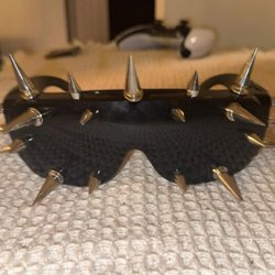 Bold black shield sunglasses with silver spike details--an edgy statement accessory for shoppers who love fearless one-of-a-kind fashion. @