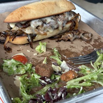 Andersons Eatery and Distillery - Prime Rib sandwich and what's left of his Caesar salad. - Whiskey Bars Near Me - Denton, Texas