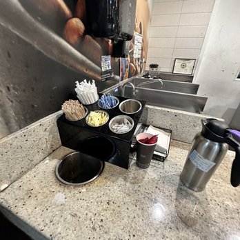Peet's Coffee & Tea - a counter with a coffee pot and cups - Coffee & Tea Near Me - Jamaica, New York