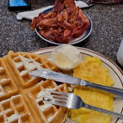 Belgian waffle with scrambled eggs and a side of bacon