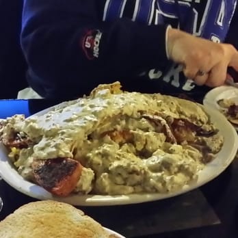 The Buttered Biscuit - Lumberjack jubilee which is a ton of food filled with kielbasa, eggs, potatoes, ham, cornbread, and smothered in sausage gravy. - New American Near Me - Sumner, Washington The Buttered Biscuit - Lumberjack jubilee which is a ton of food filled with kielbasa, eggs, potatoes, ham, cornbread, and smothered in sausage gravy. - New American Near Me - Sumner, Washington