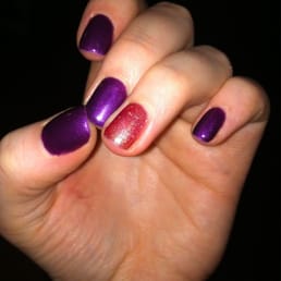 Purple nails with a orange/gold accent.