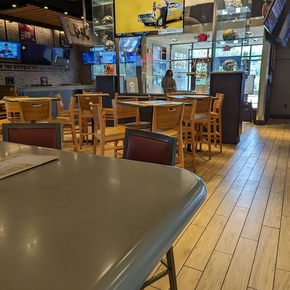 Buffalo Wild Wings - tables and chairs in a restaurant - Chicken Wings Near Me - Monroe, North Carolina Buffalo Wild Wings - tables and chairs in a restaurant - Chicken Wings Near Me - Monroe, North Carolina