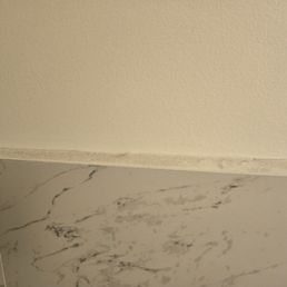 Inside bathroom. Wall tile edge. Not clean at all. Tells you all there is to know about management and owners of the business.