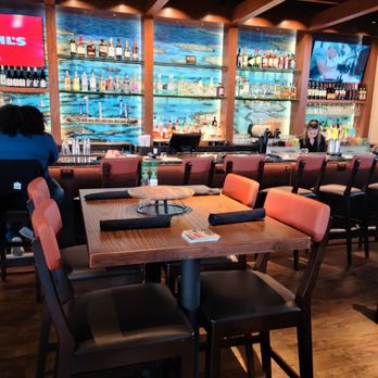 Outback Steakhouse - a dining area with tables and chairs - Steakhouses Near Me - Allen, Texas