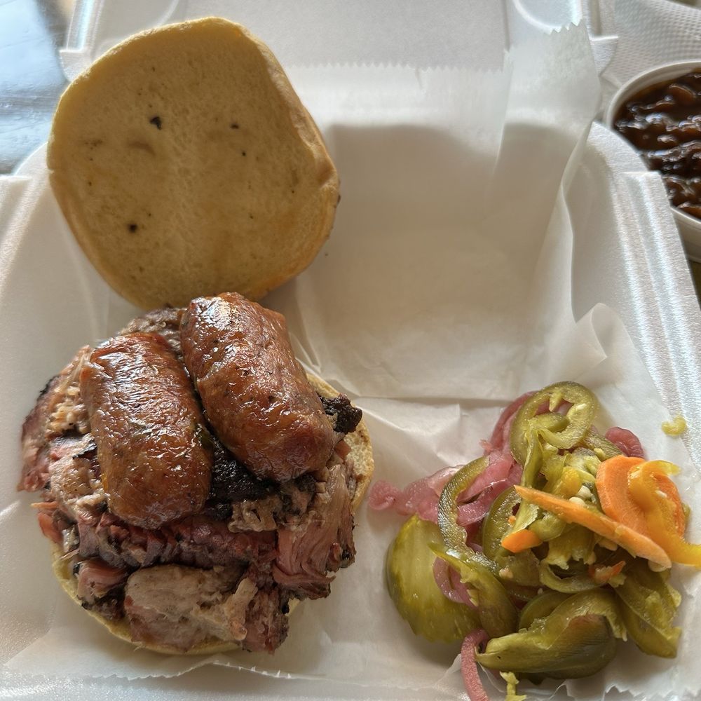Chef J BBQ - MVP sandwich on a potato roll served with pickled vegetables  The meats were pulled pork, burnt ends & sausage - Barbeque Near Me - Kansas City, Missouri