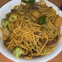a plate of noodles with meat and vegetables