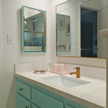 Starlight Marble & Granite - a bathroom vanity with two mirrors - General Contractors Near Me - Livermore, California