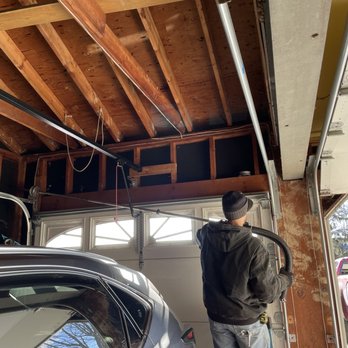 Bartlett Door Sales & Service - Technician replacing the spring. - Garage Door Services Near Me - Tonawanda, New York Bartlett Door Sales & Service - Technician replacing the spring. - Garage Door Services Near Me - Tonawanda, New York