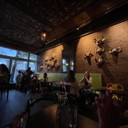 people sitting at tables in a restaurant people sitting at tables in a restaurant