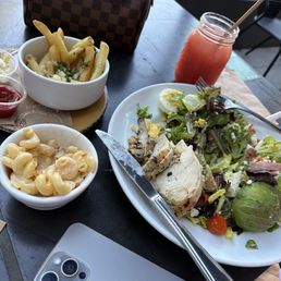 Grilled chicken, Cobb salad, macaroni and cheese and french fries sides Grilled chicken, Cobb salad, macaroni and cheese and french fries sides