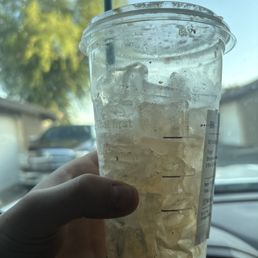 A cup of ice with a splash of coffee instead of coffee with some ice.