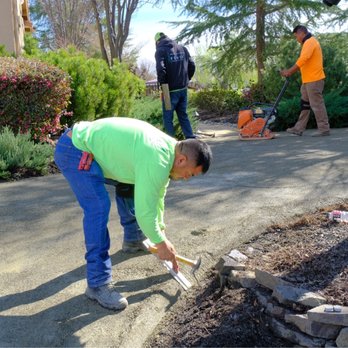 Artificial Turf By Fenix - tamping down gravel surface beneath turf creating the natural border that's so beautiful - Artificial Turf Near Me - Rocklin, California Artificial Turf By Fenix - tamping down gravel surface beneath turf creating the natural border that's so beautiful - Artificial Turf Near Me - Rocklin, California