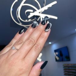 Q Nail Lounge - Gel-x builder set with black gel polish and cat-eye glitter gel on top  a magnet is used to manipulate the metals/glitter effect.