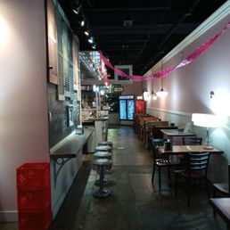 The back entrance showing the dine-in tables as well as a bartop with stools on the left. The back entrance showing the dine-in tables as well as a bartop with stools on the left.