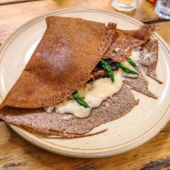 Spanel - a plate of food on a wooden table - Creperies Near Me - Montreal, Quebec