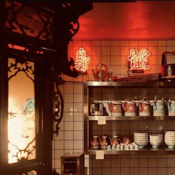 Petit Poisson Dumpling - a shelf of dishes and cups - Asian Fusion Near Me - Montreal, Quebec